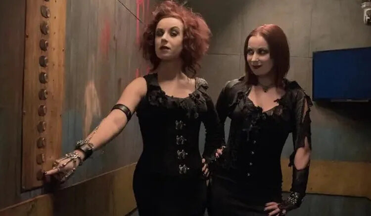 Jen and Sylvia Soska press a button in the Hellevator