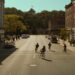 A group of kids ride their bikes through the streets of Derry in It: Welcome to Derry