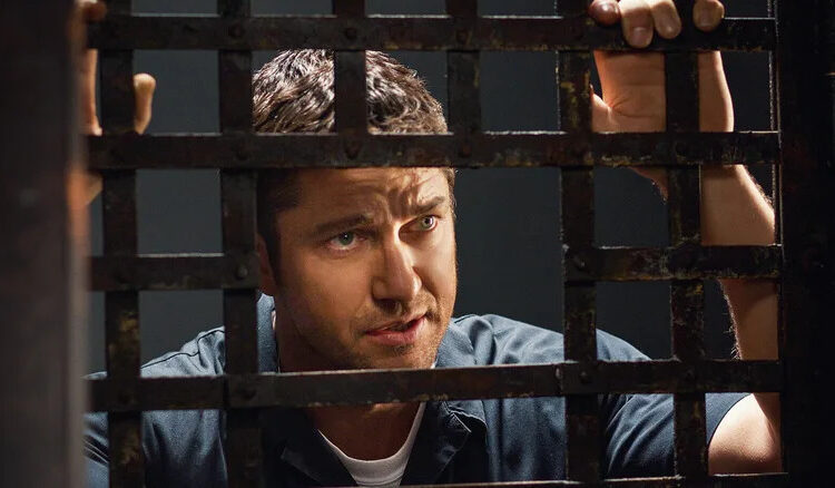 Nick looks out from behind bars in Law Abiding Citizen