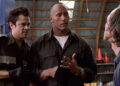 Ray and Chris talking to a bad guy in a warehouse in Walking Tall