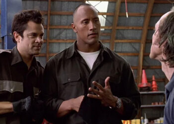 Ray and Chris talking to a bad guy in a warehouse in Walking Tall