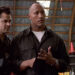 Ray and Chris talking to a bad guy in a warehouse in Walking Tall