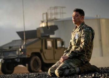 Major Daniel Gonzalez kneels in front of a military truck in "A House of Dynamite"