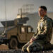 Major Daniel Gonzalez kneels in front of a military truck in "A House of Dynamite"