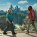 Jack Black and Jason Momoa both turn around to look back from the edge of a cliff in A Minecraft movie