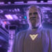A bearded Jeff Bridges in a white robe bathed by purple light in Tron: Ares