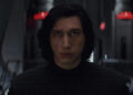A solemn Kylo Ren without his helmet stands before Snoke in The Last JEdi
