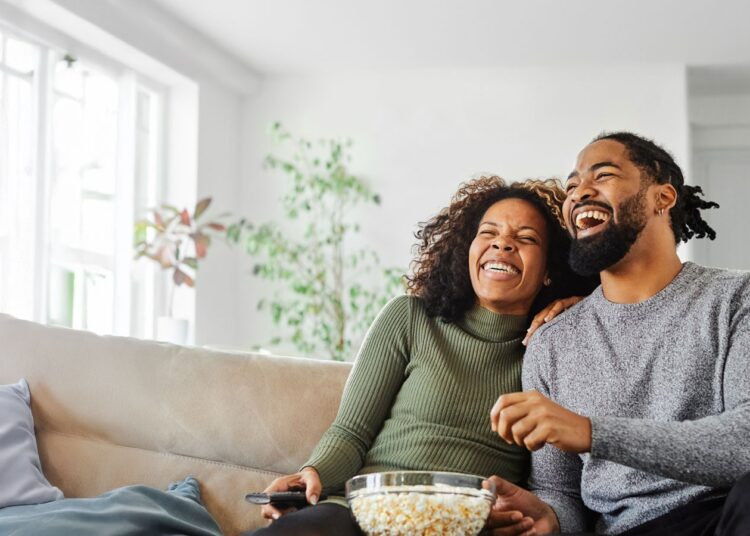 Image of tqo people watching television.