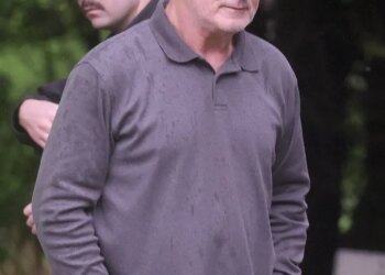 Alec Baldwin and his brother Stephen Baldwin stand after Alec Baldwin crashed his car into a tree.