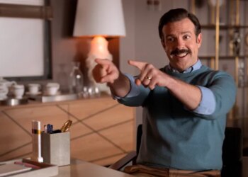 Jason Sudeikis as Ted Lasso pointing and smiling.