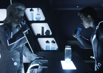 Michael Sheen as Castor drinking with Garrett Hedlund's Sam Flynn in Tron: Legacy