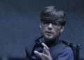 Ed Dillinger Jr. asks for calm during a tense moment in Tron: Legacy