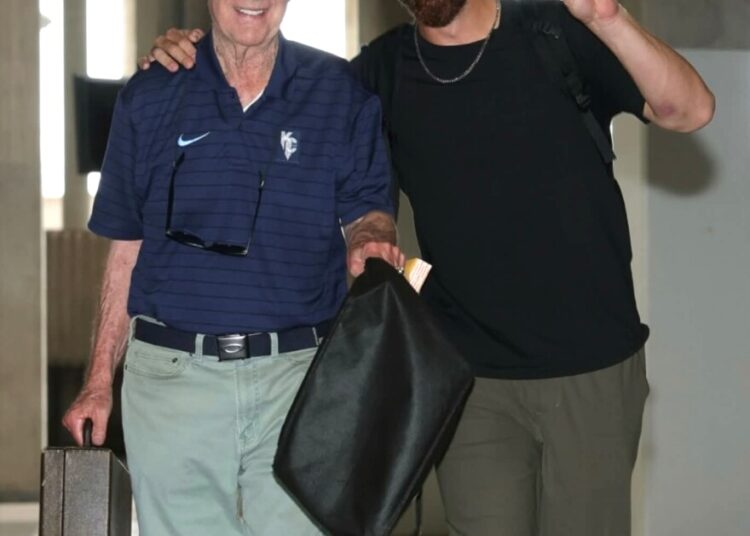 Kansas City Royals broadcaster Denny Matthews, left, and outfielder John Rave walk into Kauffman Stadium prior to a game this season at Kansas City.
