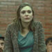 Elizabeth Olsen's Sally Owen standing up and wearing a cardigan in Red Lights