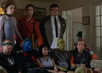 The Specials sitting on or standing behind a couch in The Specials