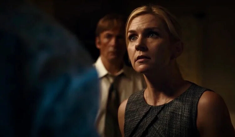 Rhea Seehorn as Kim Wexler on Better Call Saul, with Bob Odenkirk as Saul Goodman in the background behind her