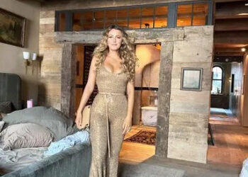 Blake Lively/Instagram Blake Lively stands in her bedroom in a gold sequin jumpsuit.