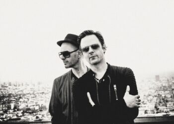 Black and White picture of two men posing for the camera.