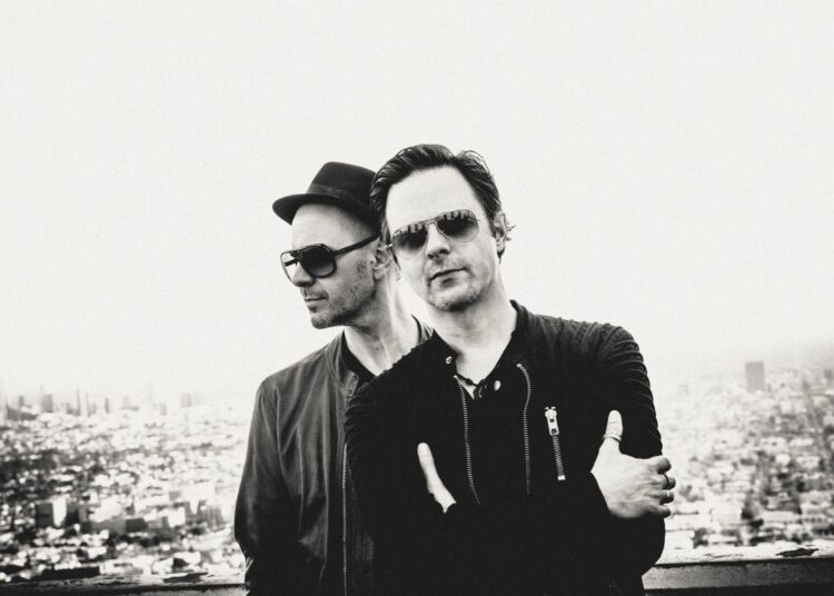 Black and White picture of two men posing for the camera.