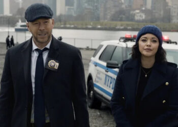 Danny Reagan and Maria Baez next to a cop car "Blue Bloods"