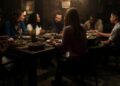 A family sitting around a dinner table eating.