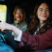 Emma Stone and Jesse Plemons in a car together in Bugonia. .