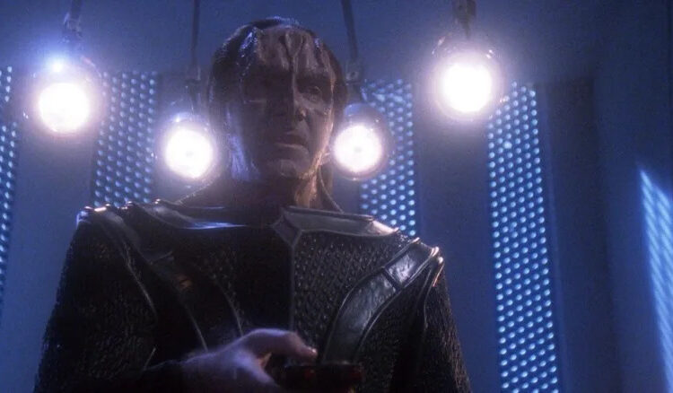 Gul Madred, surrounded by four lights in Star Trek: The Next Generation