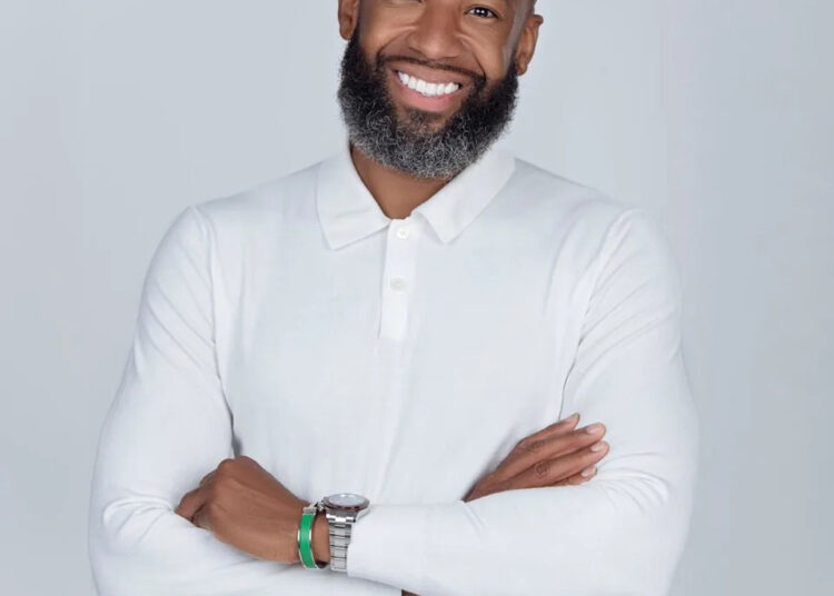 Carlos King in white shirt