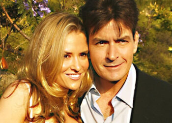 A close-up of Brooke Mueller and Charlie Sheen leaning in on each other.