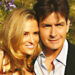 A close-up of Brooke Mueller and Charlie Sheen leaning in on each other.