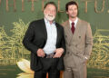 Arnold Schwarzenegger posting with Patrick Schwarzenegger