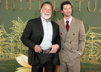 Arnold Schwarzenegger posting with Patrick Schwarzenegger