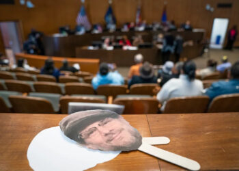 A cut out of the late Greg Mudge sits on a ledge as Detroit City Council holds a vote to decide honorary secondary street names for legendary Detroiters at the Coleman A. Young Municipal Center on Tuesday, Oct. 28, 2025 which included Mudge the late owner of Mudgie's Deli and Wine Shop in Corktown.