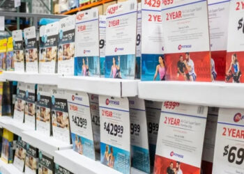 Discount deals on tickets and gym memberships shown in a display at Costco.