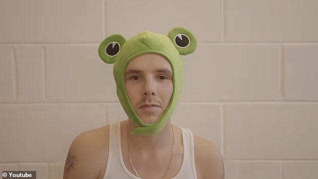 Cruz Beckham, 20, stripped off into a vest and a quirky frog hat as he released a new video for his single Lick The Toad
