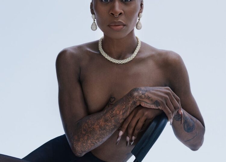 a person seated on a chair showcasing body art and accessories