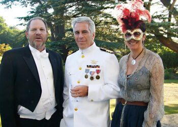 In the picture taken at Royal Lodge Harvey Weinstein is wearing a coat and tails while Jeffrey Epstein is dressed up in US military uniform clutching a wine glass and Ghislaine Maxwell an be seen wearing a feathered boa mask while grinning for the camera