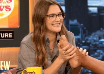 Drew Barrymore smells her co-hosts' feet during a recent broadcast of her daytime talk show.