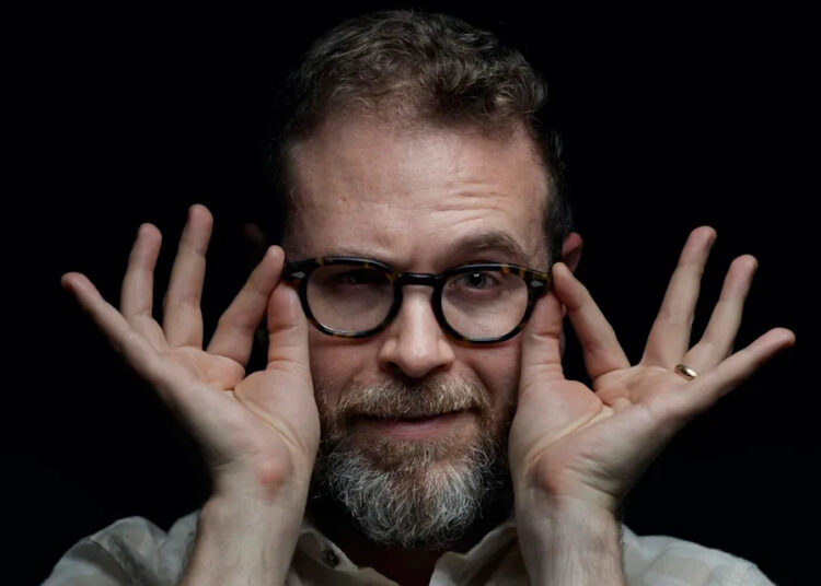 CEO Sam Reich of Dropout takes hold of his glasses