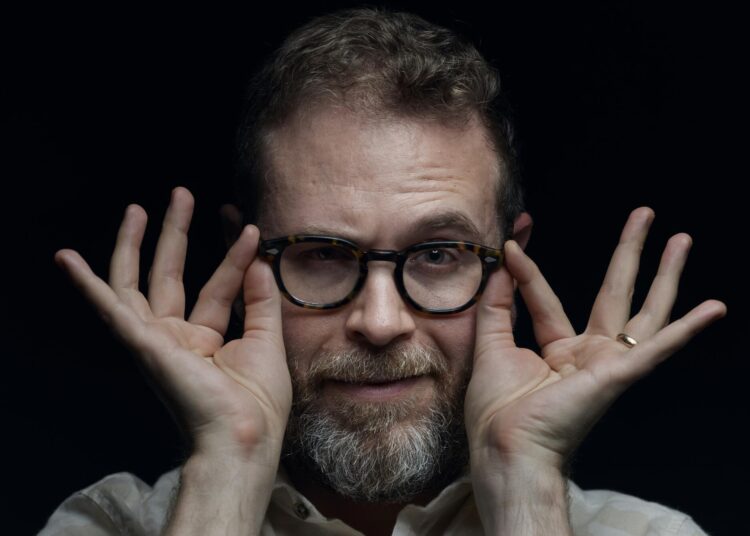 CEO Sam Reich of Dropout takes hold of his glasses