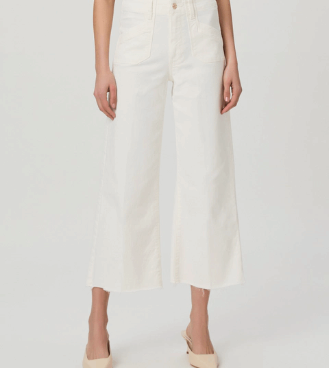 A model wearing white wide leg Paige jeans