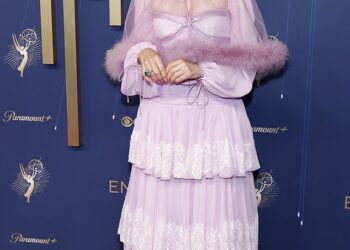 Renowned actress Parker Posey, 56, who most recently appeared in The White Lotus, arrived in an old fashioned frilly, tiered lilac gown that featured long sleeves and a sheer mini cape with a fur hem