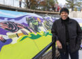 Local muralist Brian Whitfield learned to rappel to paint this piece.