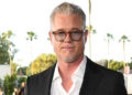 Eric Dane wears glasses with a black blazer and white shirt.