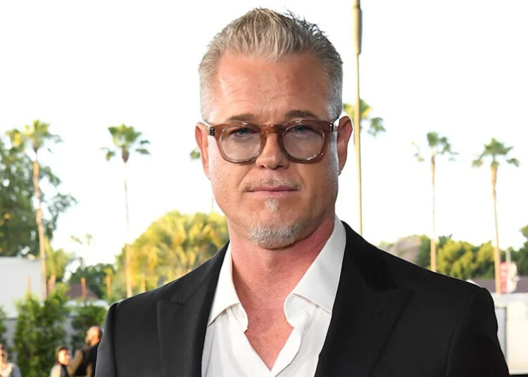Eric Dane wears glasses with a black blazer and white shirt.