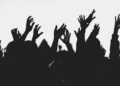 People at a concert with hands in the air