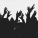 People at a concert with hands in the air