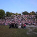 P1Harmony take a group photo with hundreds of fans during a fan meeting at Trinity Bellwoods Park.