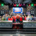 Host Guy Fieri with contestants Adam Sobel, Christian Petroni, Mei Lin, Nini Nguyen, Amanda Freitag, Aaron Sanchez, Jet Tila, Ashley Holt, Alex Guarnaschelli, Antonia Lofaso, Aarti Sequeira, Crista Luedtke, Jonathan Sawyer, Zac Young, Britt Rescigno, Sara Bradley, Damaris Phillips, Michael Voltaggio, Bryan Voltaggio, Maneet Chauhan, Stephanie Izard, Kevin Lee, Dale Talde, Shirley Chung, Sherry Yard, Marcel Vigneron, Tobias Dorzon, Marcus Samuelsson, Rachel Sherriffe, Graham Elliot, and Giuseppe Tentori, as seen on Tournament of Champions Holiday, Season 1.