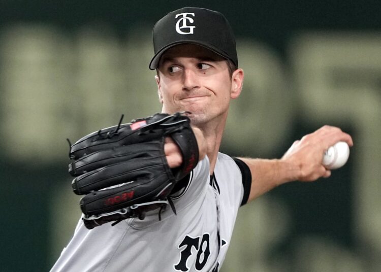 Mar 16, 2025; Bunkyo, Tokyo, Japan; Yomiuri Giants starting pitcher Foster Griffin (29) throws a pitch against the Yomiuri Giants during the first inning at Tokyo Dome. Mandatory Credit: Darren Yamashita-Imagn Images